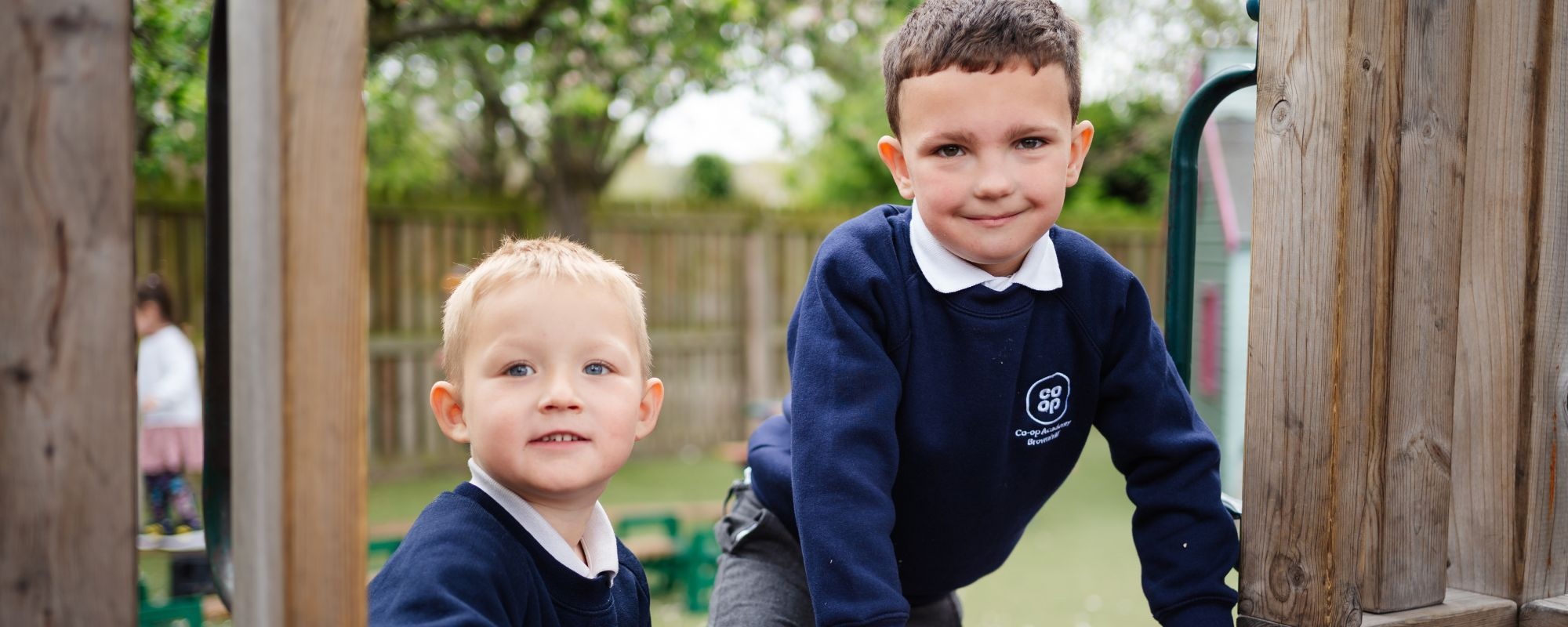 Header image showing children on tricycles